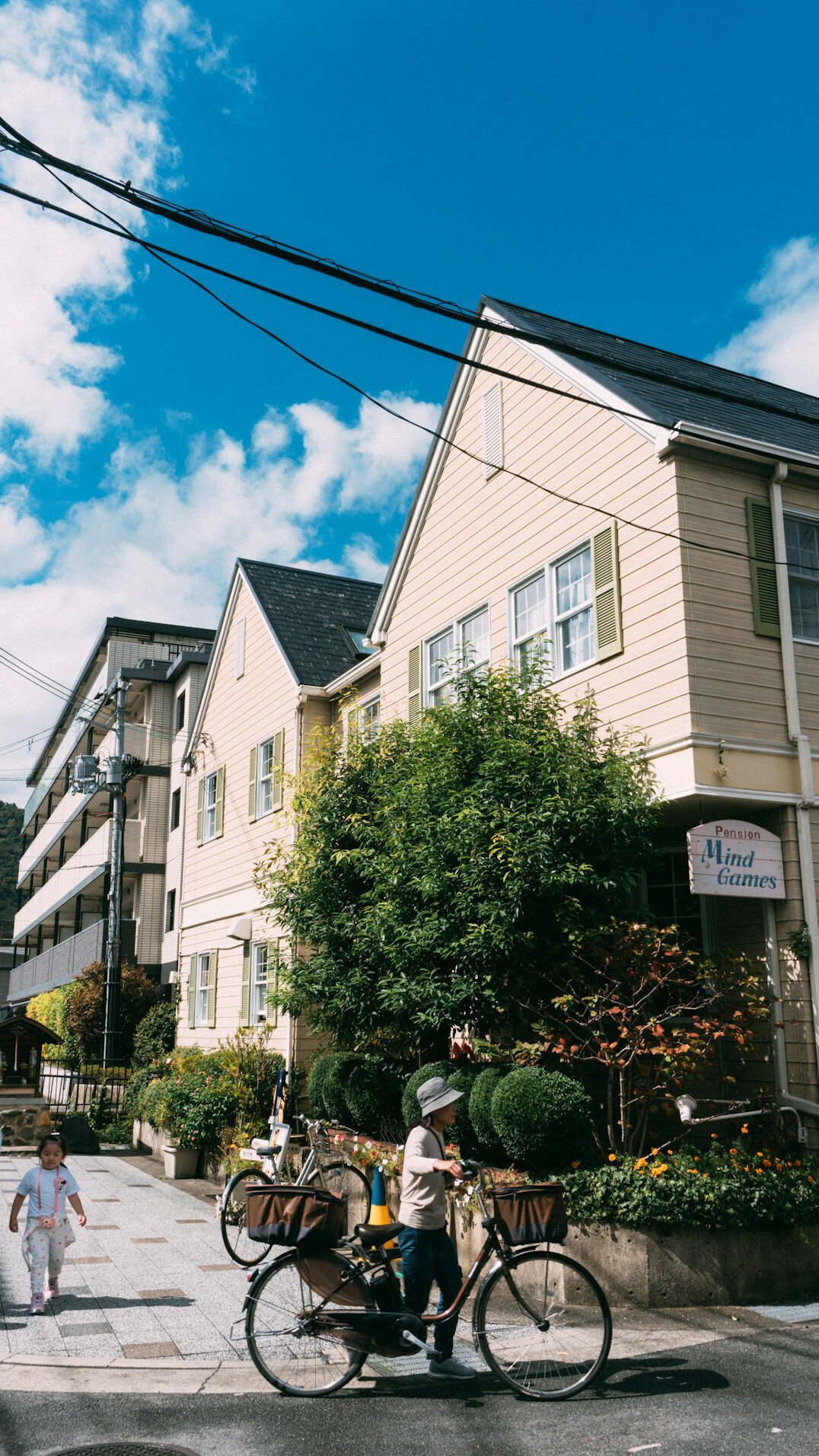 Quiet residential neighborhood street with rowhouses and parked bicycles
