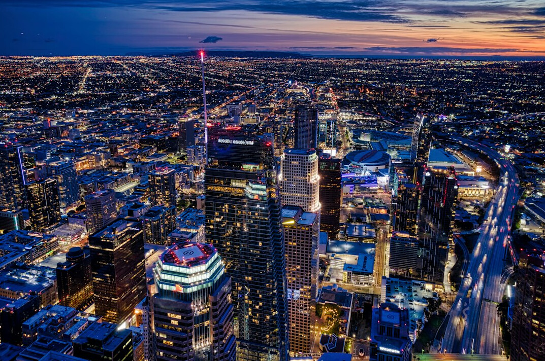 Aerial view of a Canadian city skyline at dusk with lit windows